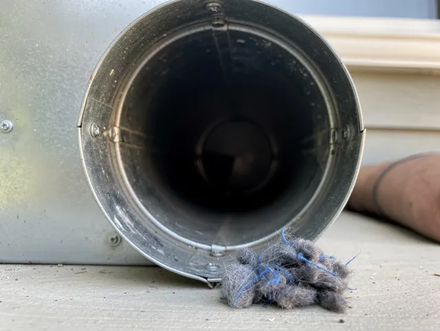 Tustin Dryer Vent Cleaning technician using specialized equipment to clear severe dryer vent blockage in Tustin